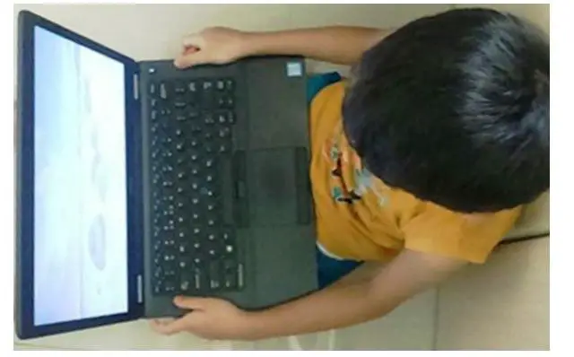 kid on laptop playing game