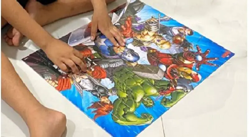 Kid playing with Avenger puzzle